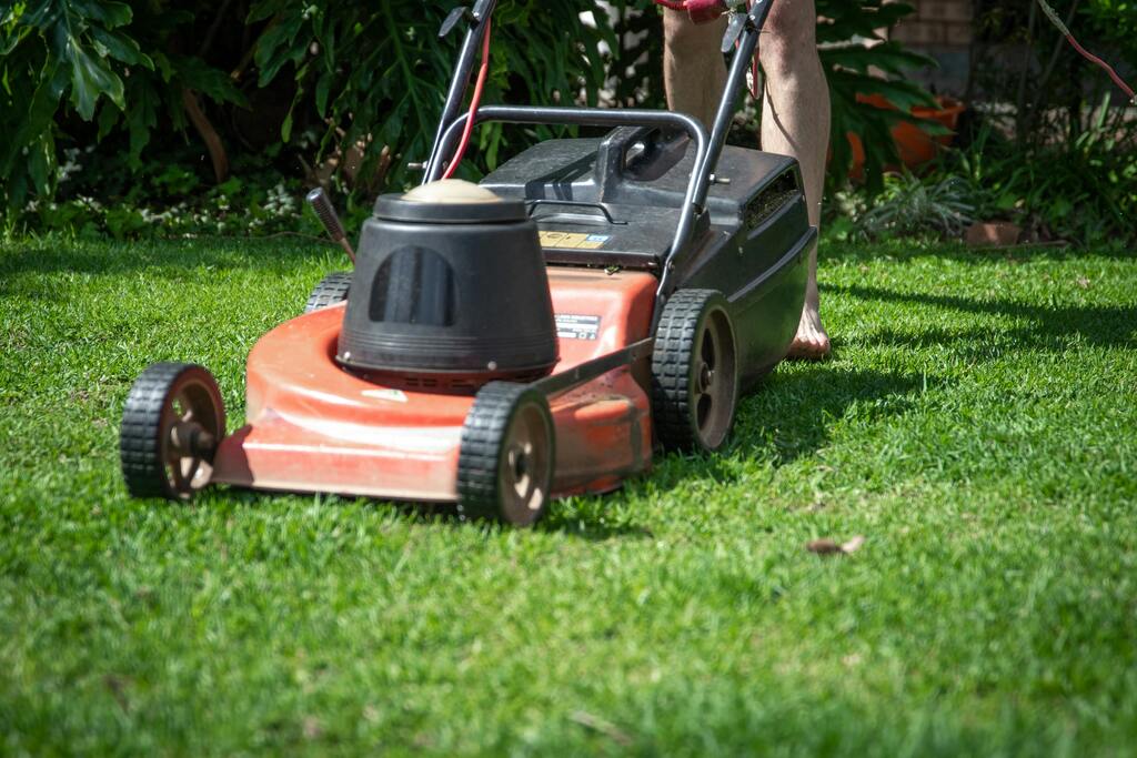 Lawn mower being used to mow grass