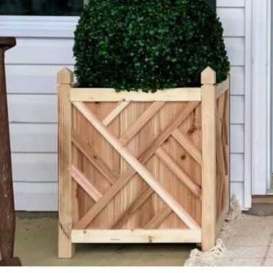 Wooden planter box with trimmed shrub by Petal's Leaf